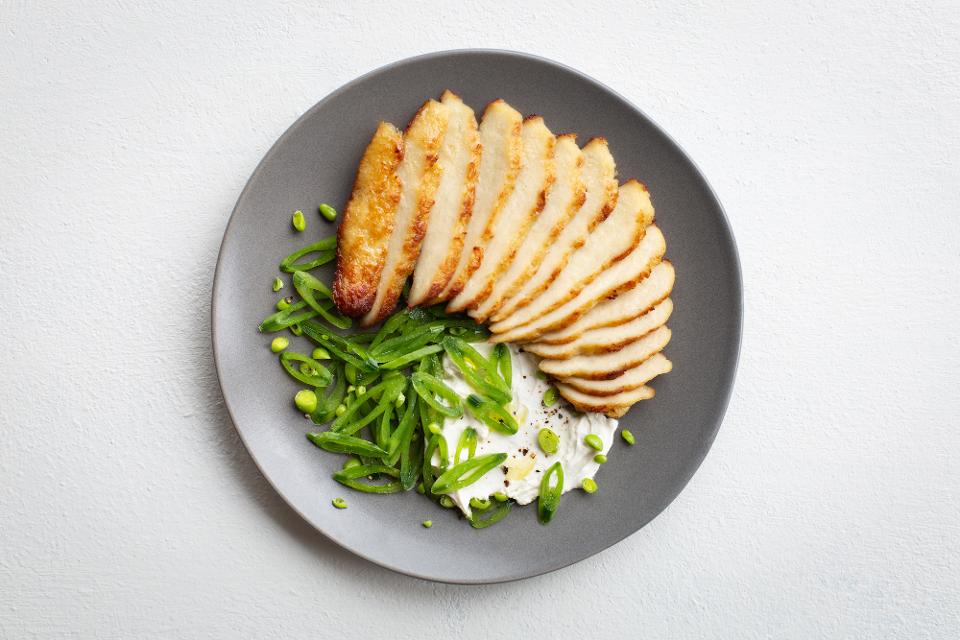 Memphis Meats' pan-seared cell-based chicken with sugar snap peas.