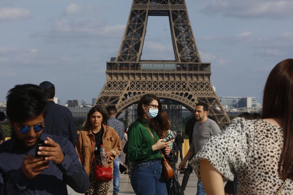 Tourists at the Trocadero Place in front of the Eiffel Tower in Paris .