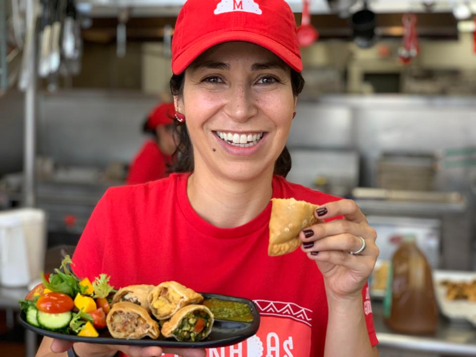 Mararita Womack with plate of empanadas