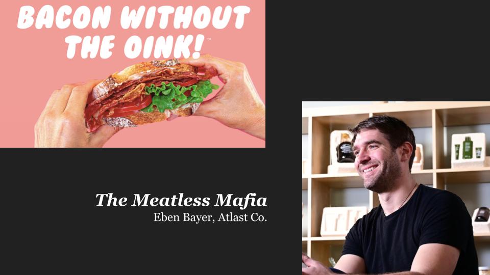 white hands holding a BLT sandwich with words ″Bacon without the oink!″ and a white man in a black shirt smiling to the left